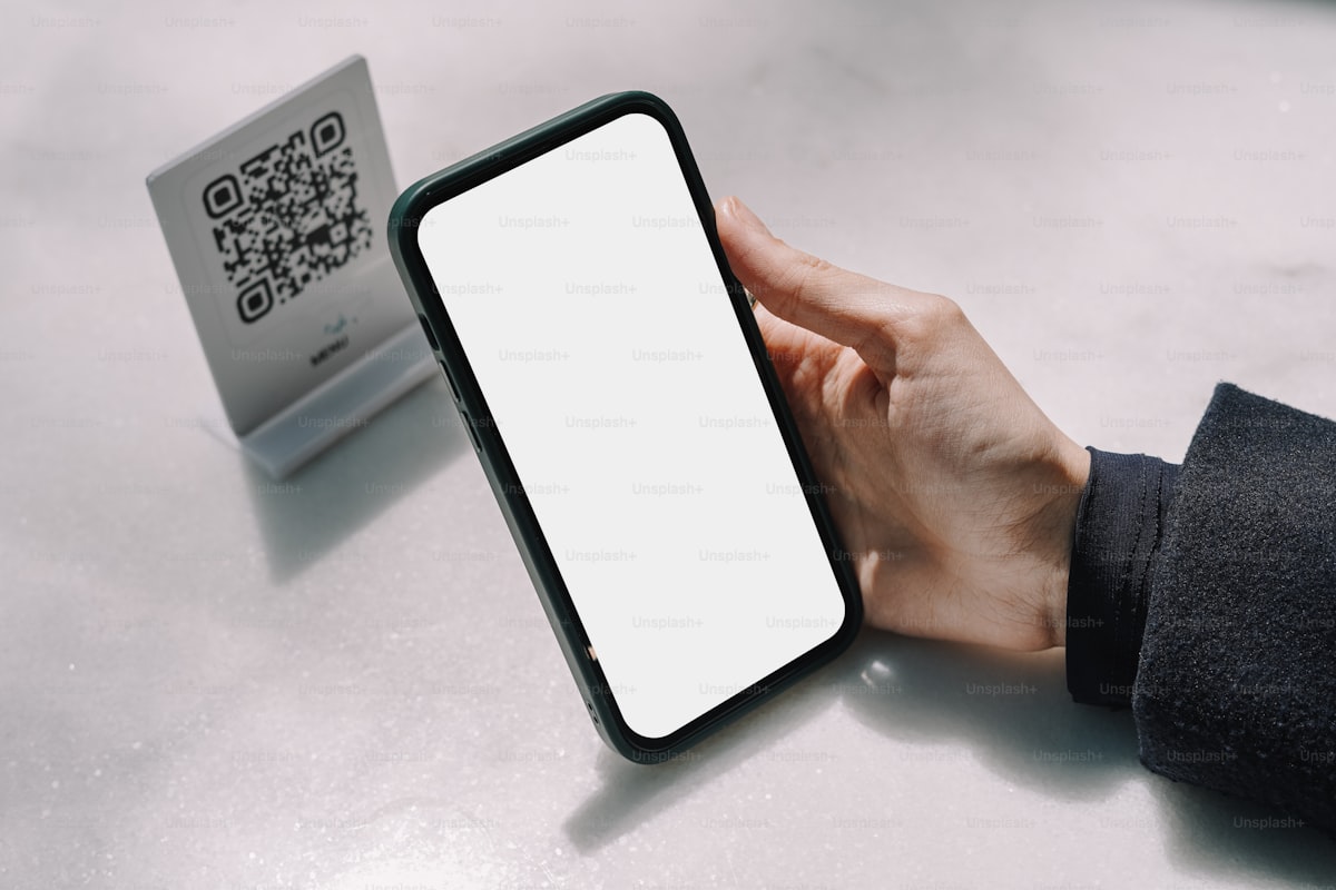 Security guard scanning QR code for gate entry verification